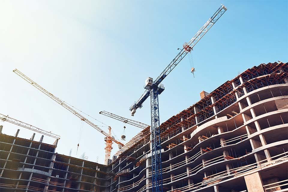 Nieuwbouwproject in de ruwbouwfase met bouwkranen